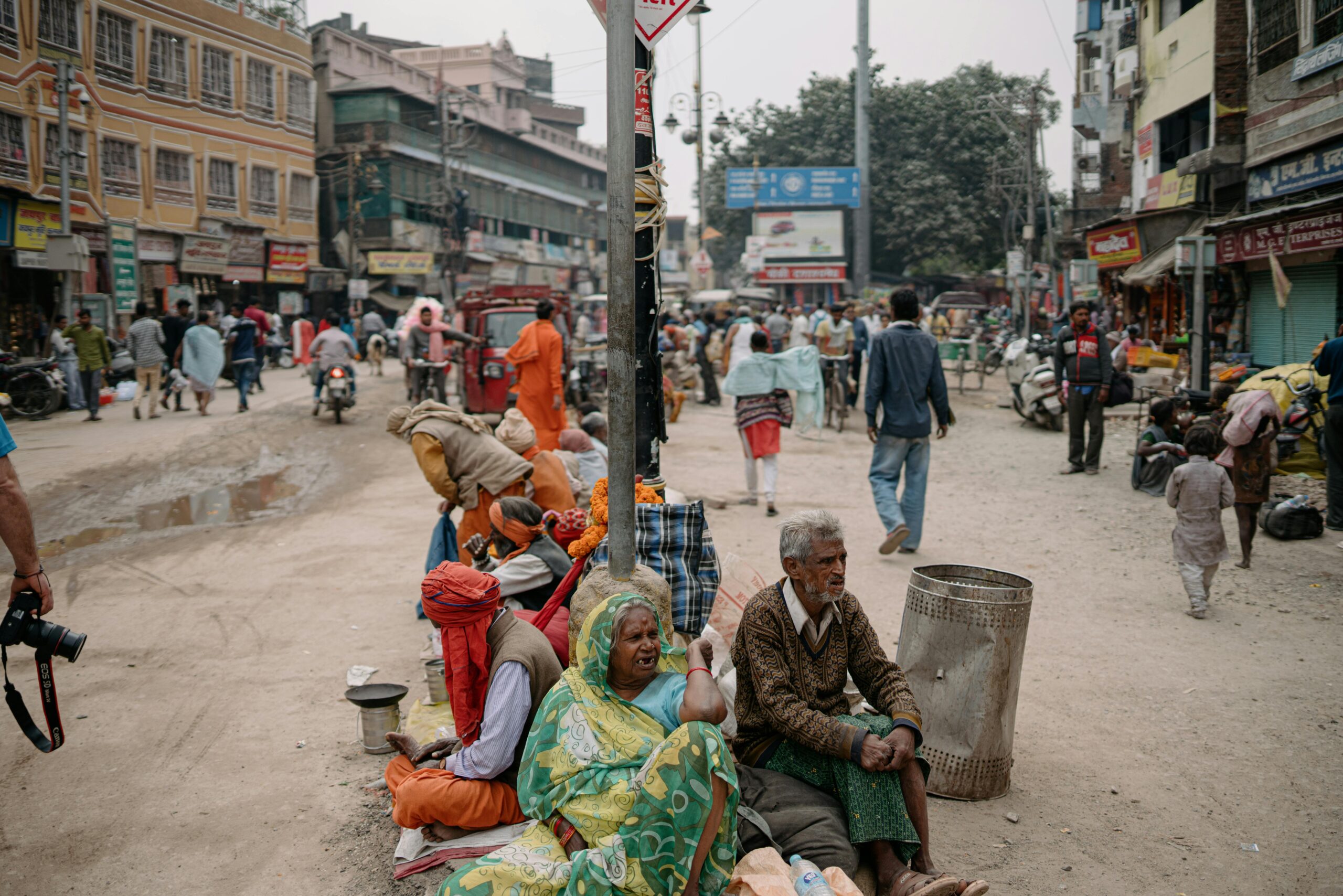 A busy street scene in Varanasi showcasing daily life with locals immersed in various activities.